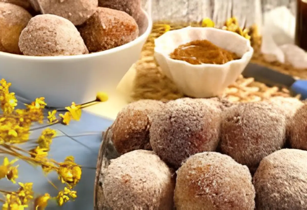 Uma mesa com tigela e bolinhos de chuva feito com leite em pó dentro.